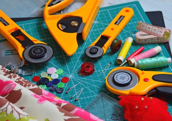 Essential sewing tools for fashion designers in a workspace