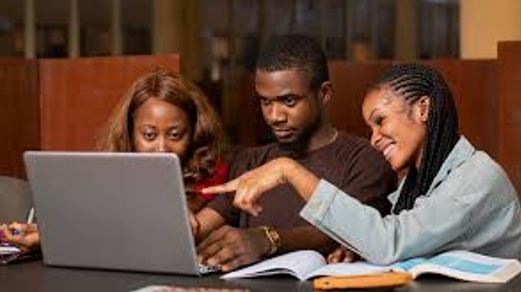 Nigerian tutor teaching students online from home using a laptop